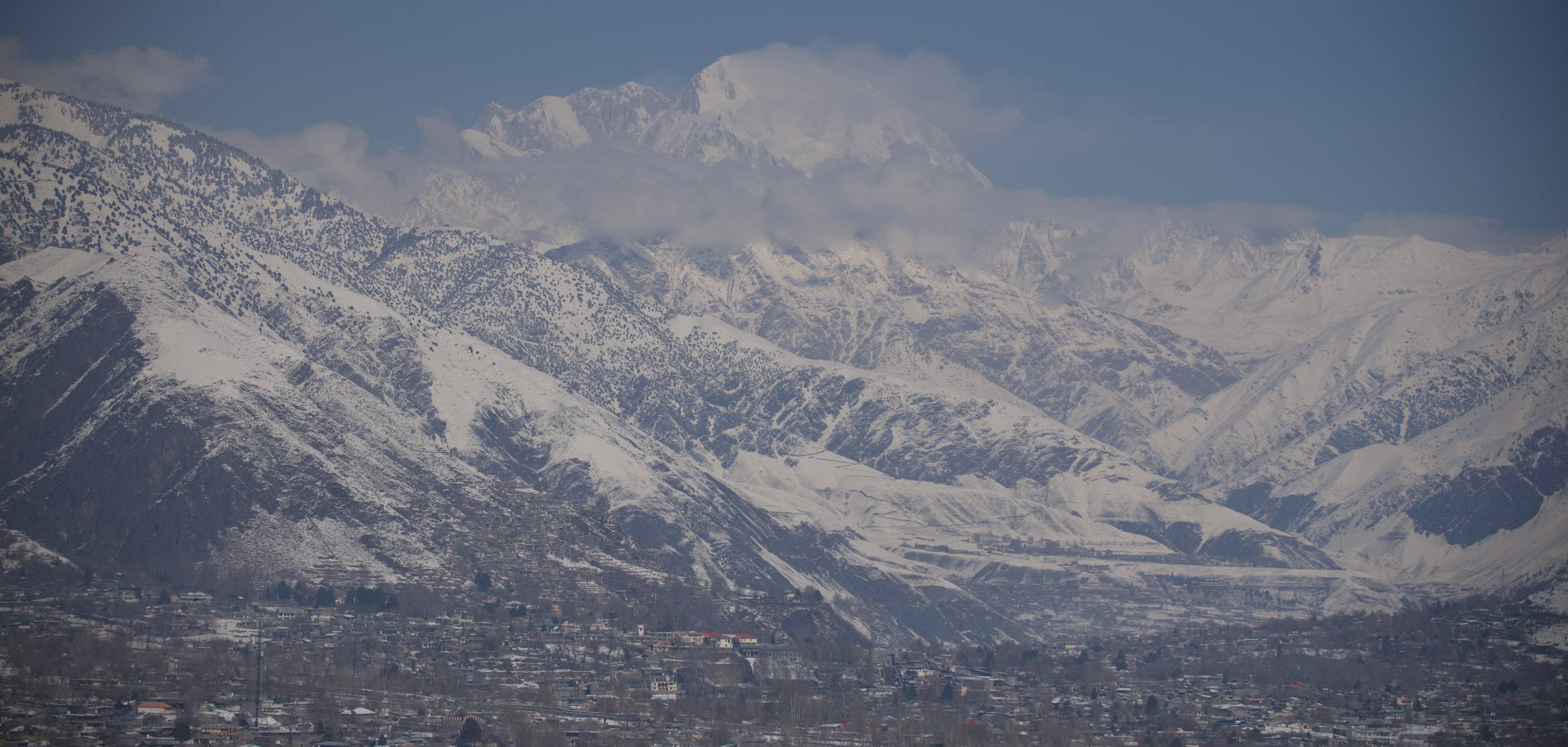 The broad Chitral Valley seen from height, river plain framed by mountains
